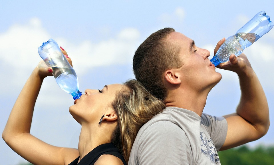 Couple drinking a bottle of water