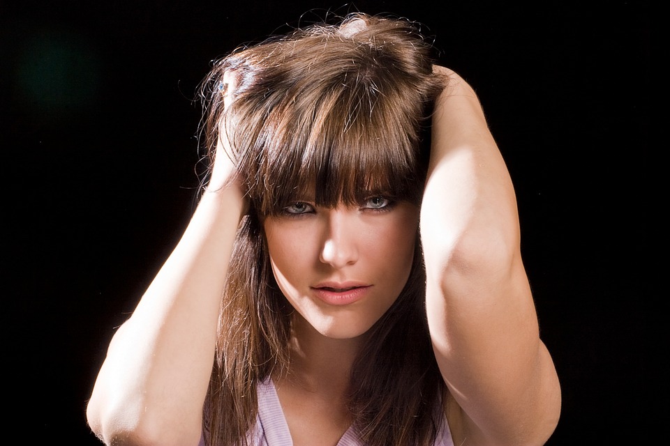 Beautiful woman holding her head