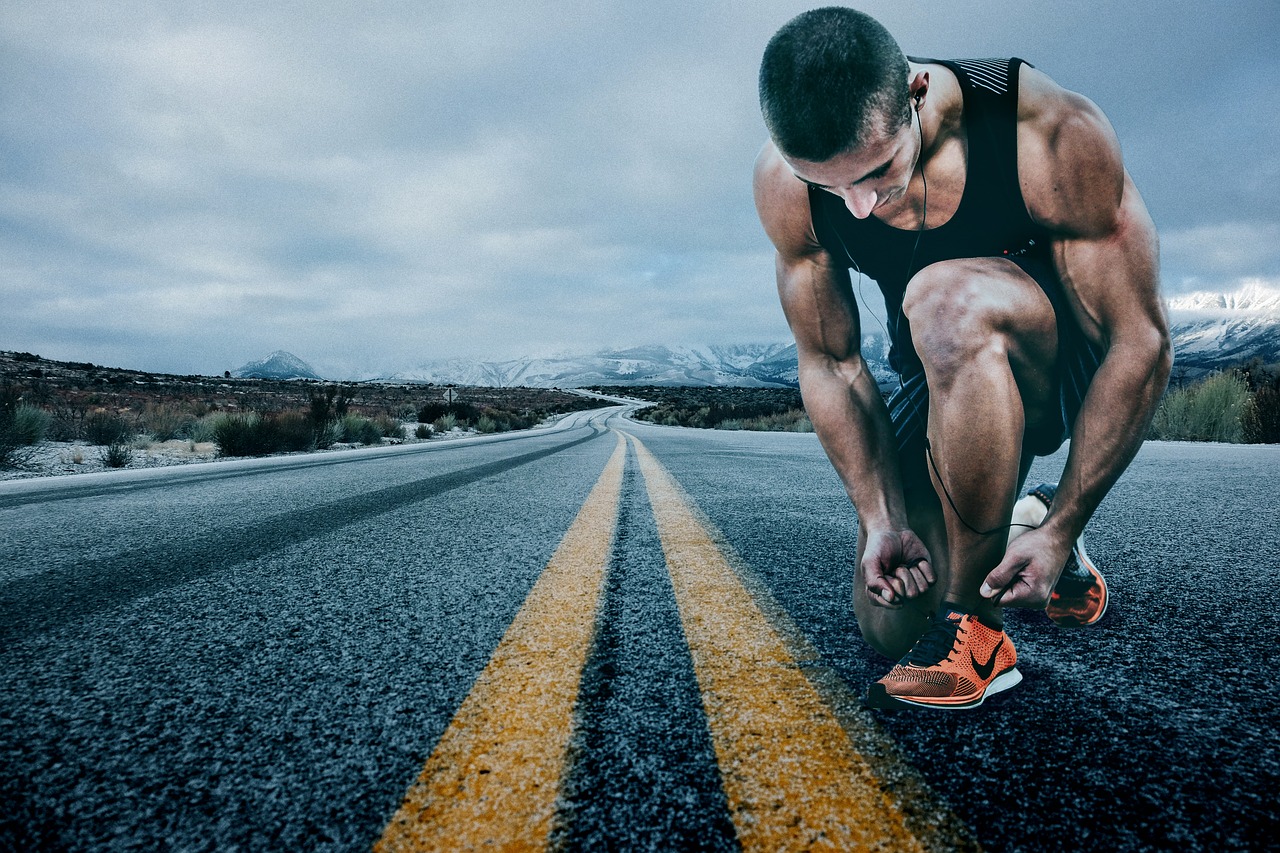 Man tying up shoe laces
